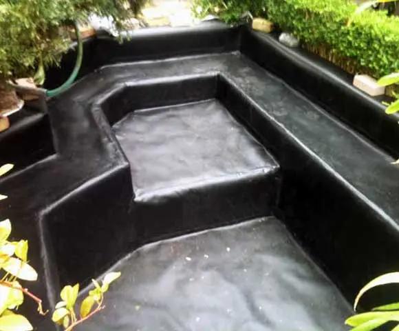 Vertical sided Koi pond lined with rubber pond liner 